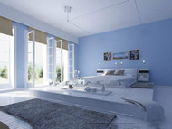 Comfortable minimalist light blue bedroom